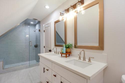 a white bathroom with a sink and a shower at 2 Mi to Tims Ford Lake! Cozy Cottage with Fireplace in Winchester