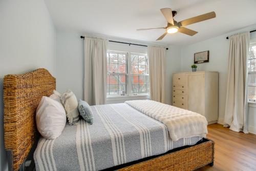 a bedroom with a bed and a ceiling fan at 2 Mi to Tims Ford Lake! Cozy Cottage with Fireplace in Winchester