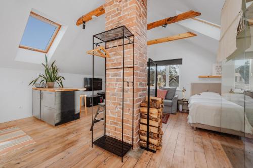 a room with a brick fireplace and a bedroom at Haapsalu home by the sea in Haapsalu