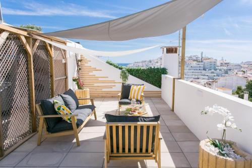 a balcony with chairs and a view of the city at Solmare Suites in Albufeira