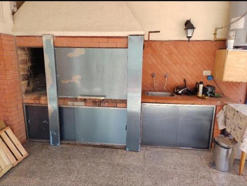 a kitchen with two sliding doors in a room at Casa Chauvin con pileta in Mar del Plata