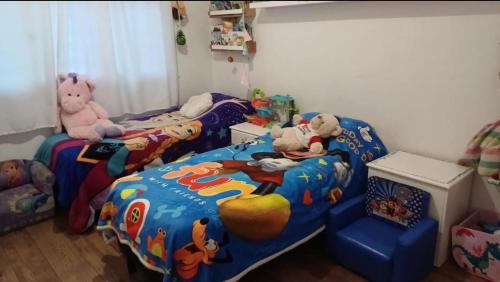 a childs bedroom with two beds with stuffed animals at Casa Chauvin con pileta in Mar del Plata
