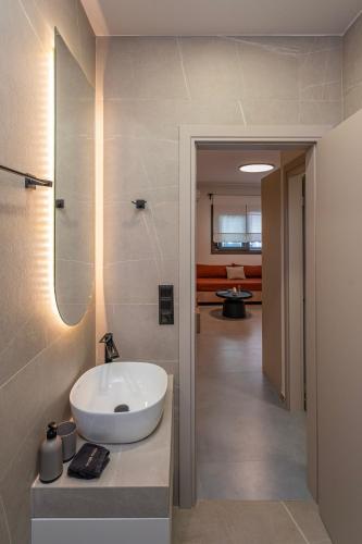 a bathroom with a sink and a mirror at Lotus Serenity Suites in Amoudara Herakliou