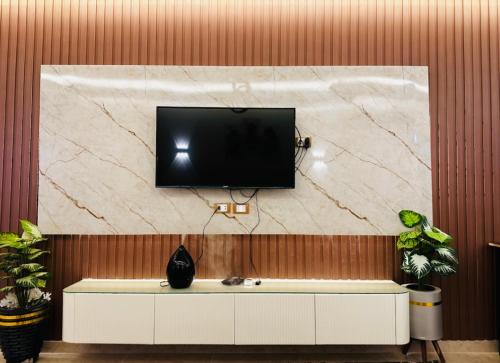 a flat screen tv on top of a wall at Amer Group Villas and Chalets on the Pool in Ain Sokhna