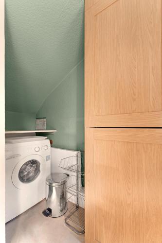 a kitchen with a stove and a washing machine at Rydal View Cottage in Ambleside
