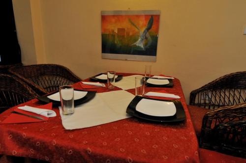 a table with a red table cloth and a red table sidx sidx sidx at Family Hotel Prolet in Shumen