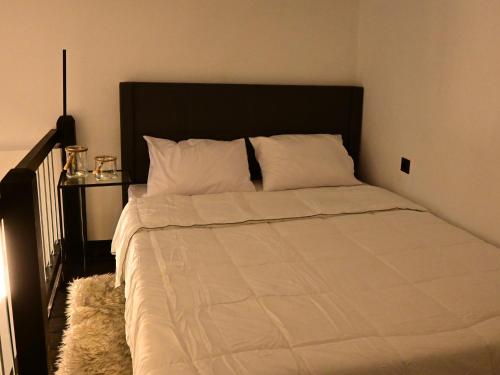 a bed with white sheets and pillows in a bedroom at NEKTAR home in Latsídha