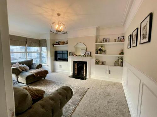 a living room with a couch and a fireplace at Seaside apartment in Bexhill