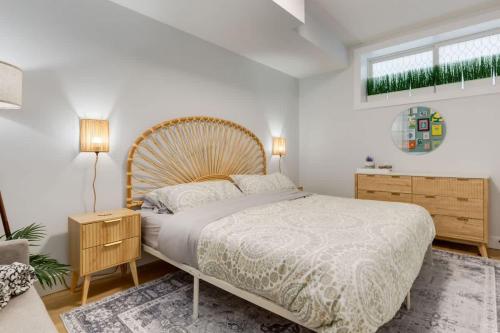 a bedroom with a large bed with a wooden headboard at Santuario Kensington - Inner City Escape in Calgary