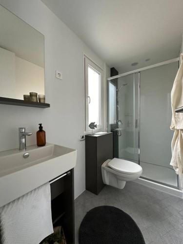 a bathroom with a sink and a toilet and a shower at Camping Kozarica Mobile Homes in Pakoštane