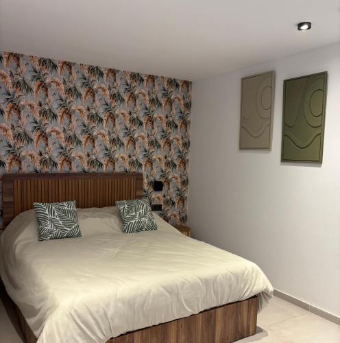 a bed with two pillows on it in a bedroom at Villa 5 suites piscine privée in Marrakesh