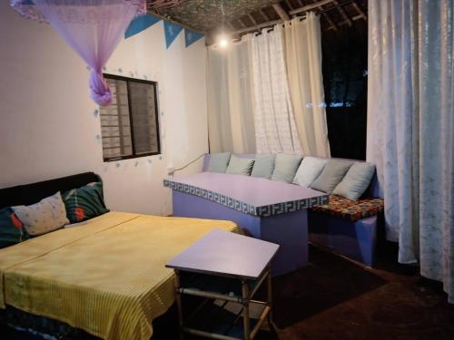 a room with two beds and a couch and a table at Daijan villa in Ukunda