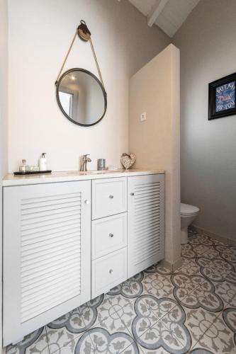 a bathroom with a sink and a mirror at Casita by the Castle in Óbidos
