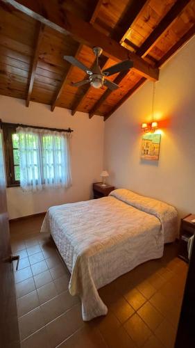 a bedroom with a bed and a ceiling fan at Casa Calamar I in Valeria del Mar