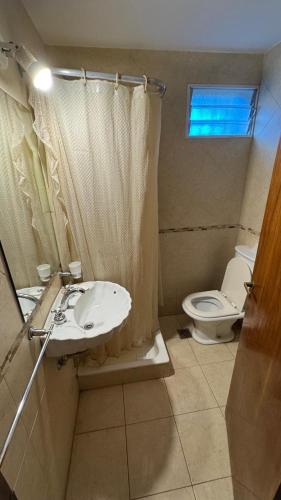 a bathroom with a sink and a toilet at Casa Calamar I in Valeria del Mar