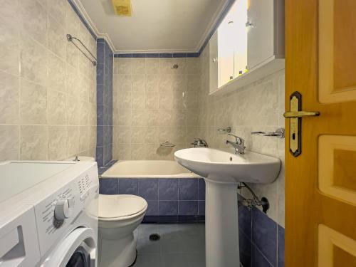 a bathroom with a sink and a toilet and a tub at Panoramio Paleochora Apartments in Palaiochóra