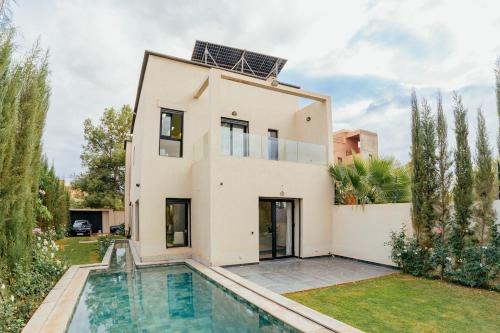 a house with a swimming pool in front of it at Stunning luxury Villa with Mountain Views in Sbiti