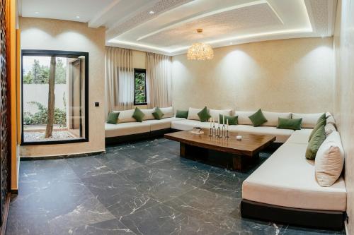 a large living room with couches and a table at Stunning luxury Villa with Mountain Views in Sbiti