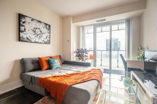 a living room with a couch and a window at Bright High Floor1 Bedroom Condo Downtown Toronto in Toronto