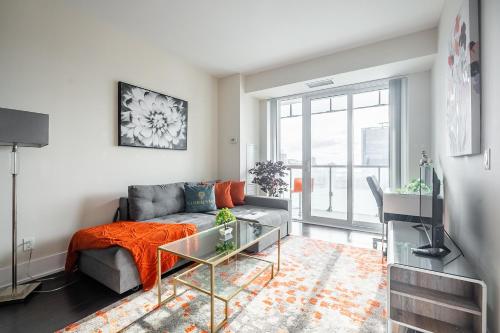 a living room with a couch and a glass table at Bright High Floor1 Bedroom Condo Downtown Toronto in Toronto