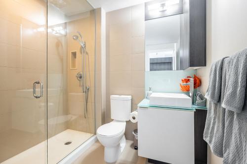 a bathroom with a shower and a toilet and a sink at Bright High Floor1 Bedroom Condo Downtown Toronto in Toronto