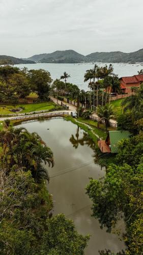 a large body of water with trees and a lake at Pousada Nosso Bosque in Porto Belo