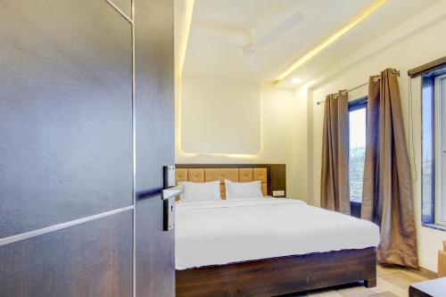 a bedroom with a bed and a sliding door at Hotel O Bonsai in Bhopal