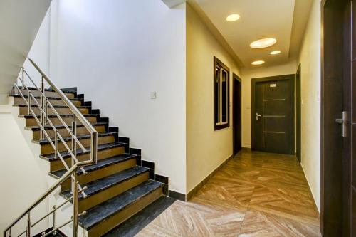 a staircase in a house with a door and a hallway at Hotel O Bonsai in Bhopal