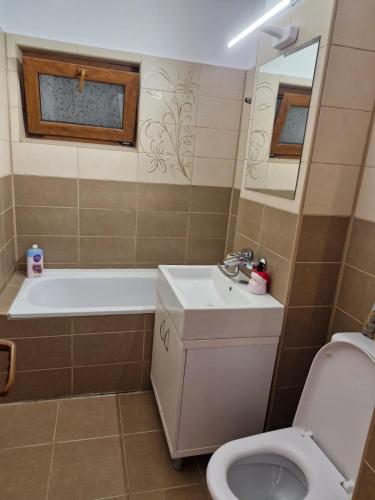 a bathroom with a tub and a toilet and a sink at Luxury stay in Craiova in Craiova