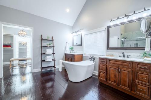 a bathroom with a tub and a sink and a mirror at Tranquility Paradise in Sevierville