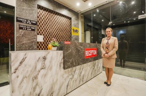 a woman standing in front of a marble counter at Fabhotel JP Villa - Nr Stadium in Varanasi