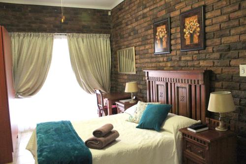 Ένα ή περισσότερα κρεβάτια σε δωμάτιο στο Steendal Guest House