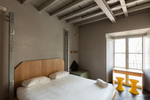 ミラノにあるCombo Milanoの白いベッドと窓のある寝室