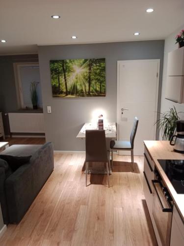 a kitchen and living room with a table and chairs at Stadtnah an der Förde 5705 in Flensburg