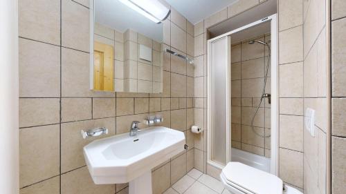 a bathroom with a sink and a shower and a toilet at Plein Ciel VA 032 - MOUNTAIN apartment 6 pers in Veysonnaz