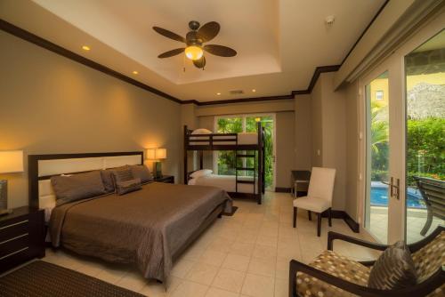 a bedroom with a bed and a ceiling fan at Vista Bahia 3D 3 bdr Ocean View in Los Suenos in Herradura