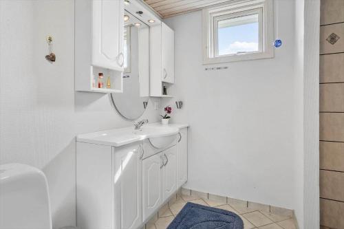 un bagno bianco con lavandino e specchio di 30493-Odder-Snekkeager-21 a Odder
