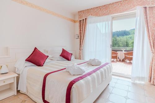 Postel nebo postele na pokoji v ubytování Hotel Miramonti