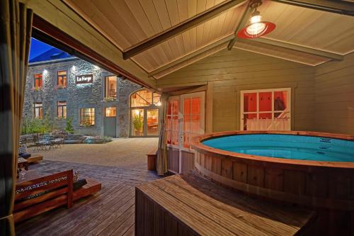 a large jacuzzi tub in a house at La Forge - Chambres d'hôtes en Ardenne in Wellin