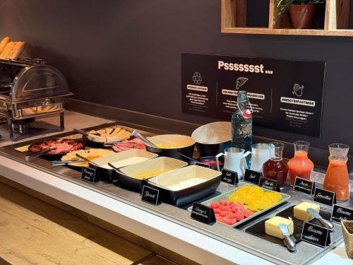 a buffet with many different types of food on a table at ibis Nîmes Ouest - A9 in Nîmes