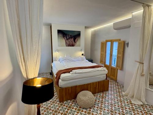 a bedroom with a large bed and a window at Casa Kai Altea - Torre de Bellaguarda in Altea
