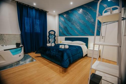 a bedroom with a bed and a bathroom with a tub at Cama Luxury Rooms in Palermo