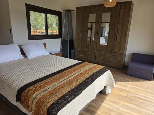 Ένα ή περισσότερα κρεβάτια σε δωμάτιο στο HOM I Cabaña La Ensenada vista parcial al Volcán