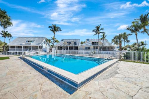 een zwembad voor een huis met palmbomen bij South Seas Beach Home 10 in Captiva