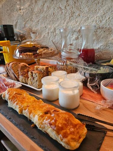a table with various types of bread and candles at Dolcevita guest house in Torreano