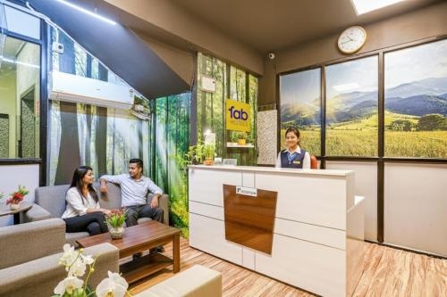 a group of people sitting in a waiting room at FabHotel Eminent - Patel Nagar, 0riental University in Bhopal