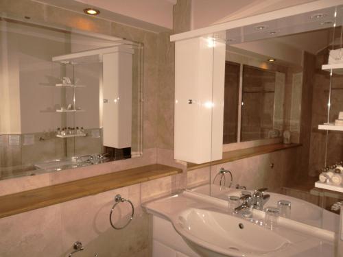 a bathroom with a sink and a mirror at King's Head Inn in Llangennith