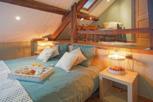 a bedroom with a bed with a tray of food on it at La Forge - Chambres d'hôtes en Ardenne in Wellin
