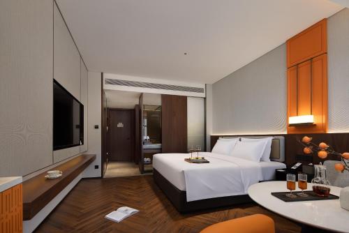 Ένα ή περισσότερα κρεβάτια σε δωμάτιο στο Yuezhi Hotel Liuyang Tianhong Shopping Center Branch