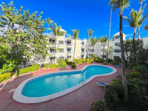 an image of a swimming pool in front of a building at TROPICAL VACATION with nice view at PLAYA LOS CORALES in Punta Cana
